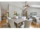 Open-concept dining area showcases a stylish table setting adjacent to the living room with vaulted ceiling at 311 Westbrook Dr, Carrboro, NC 27510