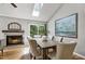 Dining area featuring a vaulted ceiling, fireplace, large windows and access to a serene outdoor deck at 311 Westbrook Dr, Carrboro, NC 27510