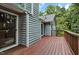Deck with stained wood floorboards and painted blue siding, offering a view of the yard at 311 Westbrook Dr, Carrboro, NC 27510