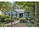 Charming home featuring a stone pathway, lush greenery, and decorative street lamp at 311 Westbrook Dr, Carrboro, NC 27510