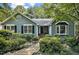 Charming home featuring a stone pathway and lush greenery leading to the inviting front entrance at 311 Westbrook Dr, Carrboro, NC 27510