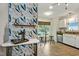 Bright kitchen offers a cozy eat-in nook with stylish floral wallpaper and modern appliances at 311 Westbrook Dr, Carrboro, NC 27510