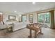 Living room with neutral tones, a sofa, foosball table, and doors opening to an outdoor area at 311 Westbrook Dr, Carrboro, NC 27510