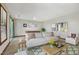 Staged living room featuring stylish furnishings, foosball table, and plenty of natural light at 311 Westbrook Dr, Carrboro, NC 27510