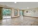 Empty living room with tile flooring, neutral walls, a patio door and large windows at 311 Westbrook Dr, Carrboro, NC 27510
