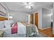 Bright bedroom features a king bed, hardwood floors, and a view to the ensuite bathroom at 311 Westbrook Dr, Carrboro, NC 27510