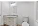 Bathroom with granite countertop, white cabinets, modern fixtures, and wood-look flooring at 3218 Seven Springs Rd, Hillsborough, NC 27278