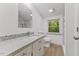 Bright bathroom with white cabinets, granite countertop, and a window letting in natural light at 3218 Seven Springs Rd, Hillsborough, NC 27278