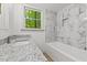 Bathroom featuring granite countertop, white cabinets and a tub with tiled walls at 3218 Seven Springs Rd, Hillsborough, NC 27278