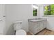 Bathroom featuring granite countertop, white cabinets, toilet and mirror at 3218 Seven Springs Rd, Hillsborough, NC 27278