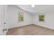 Bedroom with two windows overlooking outside scenery and hardwood floors at 3218 Seven Springs Rd, Hillsborough, NC 27278