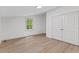 Spacious bedroom with wood-look flooring, window, and a closet at 3218 Seven Springs Rd, Hillsborough, NC 27278