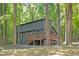 Charming exterior showcasing a spacious deck and wooded surroundings, blending nature with comfortable living at 3218 Seven Springs Rd, Hillsborough, NC 27278