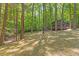 A charming home is nestled in a tranquil wooded setting, offering a serene retreat with mature trees at 3218 Seven Springs Rd, Hillsborough, NC 27278