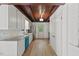 Well-lit kitchen featuring white cabinets, subway tile backsplash, and wood flooring at 3218 Seven Springs Rd, Hillsborough, NC 27278