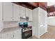 Bright kitchen with white cabinets, granite counters, and a stainless steel range at 3218 Seven Springs Rd, Hillsborough, NC 27278