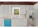 Kitchen with white cabinets, granite countertops, stainless steel appliances, and view of the surrounding forest at 3218 Seven Springs Rd, Hillsborough, NC 27278