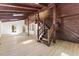 Spacious living room with hardwood floors, wood walls, exposed wood beams and a wooden staircase at 3218 Seven Springs Rd, Hillsborough, NC 27278