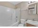 Bathroom featuring a combined tub and shower with neutral wall color and wood cabinets at 3352 Tarleton W, Durham, NC 27713