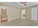 Spacious bedroom with ceiling fan, ensuite bathroom, closet, and carpet flooring at 3352 Tarleton W, Durham, NC 27713