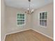 Charming dining room featuring wood floors, natural light from two windows, and chandelier at 3352 Tarleton W, Durham, NC 27713