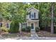 Charming two-story home with tan siding, lush landscaping, and a welcoming front entrance at 3352 Tarleton W, Durham, NC 27713