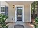Close-up view of a front door with glass and a house number on the side at 3352 Tarleton W, Durham, NC 27713