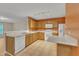 Bright kitchen with tile flooring, wooden cabinets, and modern white appliances at 3352 Tarleton W, Durham, NC 27713