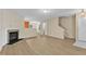 View of the open concept living room with a fireplace and luxury vinyl floors at 3352 Tarleton W, Durham, NC 27713