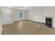 Living room featuring luxury vinyl flooring, white trim, and a gas fireplace with modern tile at 3352 Tarleton W, Durham, NC 27713