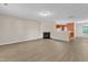 Open-concept living room with luxury vinyl flooring, gas fireplace, and natural light at 3352 Tarleton W, Durham, NC 27713