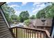 View from the balcony showing lush treetops, multiple parked cars, and apartment buildings at 346 Summerwalk Cir, Chapel Hill, NC 27517
