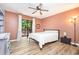 Well-lit bedroom with vinyl floors, closet, ceiling fan, and balcony access at 346 Summerwalk Cir, Chapel Hill, NC 27517