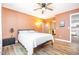 Cozy bedroom with warm paint, vinyl floors, closet, and direct kitchen access at 346 Summerwalk Cir, Chapel Hill, NC 27517