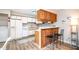 View of kitchen with white cabinets, bar seating, and nearby laundry area at 346 Summerwalk Cir, Chapel Hill, NC 27517