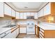 A functional kitchen with ample counter space, white cabinets, and modern appliances at 346 Summerwalk Cir, Chapel Hill, NC 27517