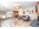 Open-concept living area with a modern sofa, fireplace, and seamless flow to the kitchen and dining space at 346 Summerwalk Cir, Chapel Hill, NC 27517