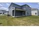 The backyard boasts a covered patio, a lush lawn, and gray siding at 3509 Bailey Lake Dr, Fuquay Varina, NC 27526