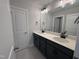 Modern bathroom featuring dual sinks, quartz countertops, and stylish vanity lighting at 3509 Bailey Lake Dr, Fuquay Varina, NC 27526