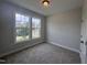 Cozy bedroom with plush carpet and large windows offering abundant natural light and neighborhood views at 3509 Bailey Lake Dr, Fuquay Varina, NC 27526