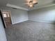 Spacious carpeted bedroom with tray ceiling and fan is well lit and has neutral walls at 3509 Bailey Lake Dr, Fuquay Varina, NC 27526