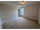 Neutral bedroom features plush carpeting, a window for natural light, and an adjoining door at 3509 Bailey Lake Dr, Fuquay Varina, NC 27526