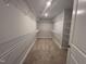 Walk-in closet featuring carpet flooring and multiple rows of wire shelving for ample storage at 3509 Bailey Lake Dr, Fuquay Varina, NC 27526