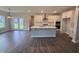 Open-concept kitchen flows into the living area with stainless steel appliances and a center island for dining at 3509 Bailey Lake Dr, Fuquay Varina, NC 27526