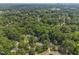 Overhead view of neighborhood with mature trees and well-maintained homes at 404 Troy Pl, Raleigh, NC 27609