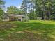 Backyard with mature trees and a storage shed at 404 Troy Pl, Raleigh, NC 27609