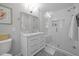 Modern bathroom with white vanity, marble countertop, and glass-enclosed shower at 404 Troy Pl, Raleigh, NC 27609