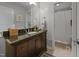 Bathroom with granite vanity, large mirror, and shower with tile surround at 404 Troy Pl, Raleigh, NC 27609