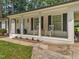 Inviting porch with rocking chairs, black shutters, and white columns, perfect for relaxing at 404 Troy Pl, Raleigh, NC 27609