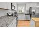 Well-appointed kitchen with granite countertops, stainless steel appliances, and ample cabinet space at 404 Troy Pl, Raleigh, NC 27609